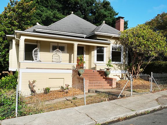 The front of house on a quiet street in Arcata, featuring a covered porch and landscaped yard.