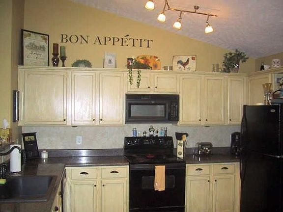 updated kitchen with custom french country cabinetry and granite sink