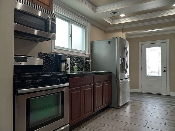 Microwave refrigerator and oven are not included in sale. But the dishwasher is. The sink features a commercial style pull-down sprayer and integrated hand soap dispenser. Hookup for gas stove. Water hookup for refrigerator. The kitchen windows have a Privacy Film on them which could be removed but are nice because they let plenty of light in while obscuring The View for more privacy