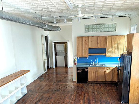 kitchen with laundry closet in background. Track lighting, ceiling lights, and 2 new 8' long fluorescents in the mainroom
