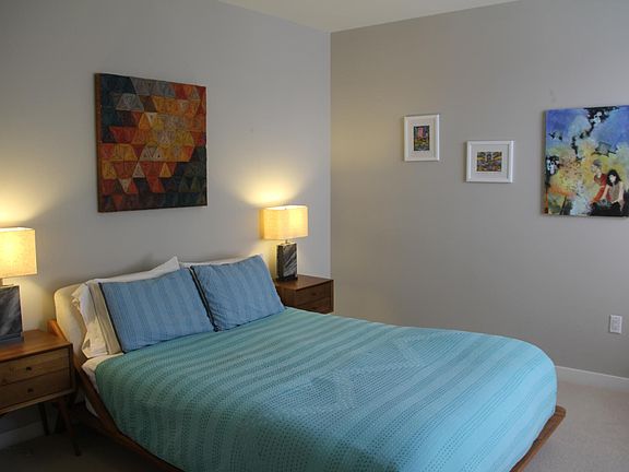Spacious bedroom with queen-size bed, large closet, and reading nook.