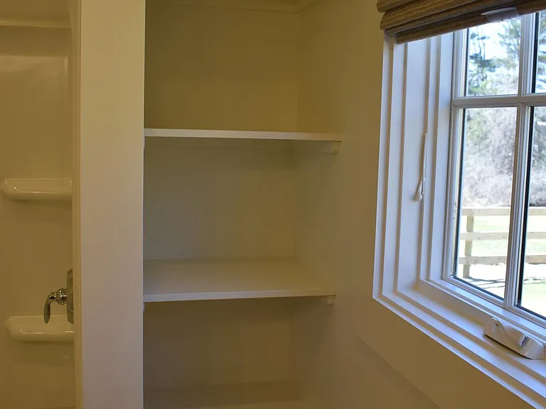 Secondary Bathroom built-in storage space. This bathroom has a tub/shower and vanity.