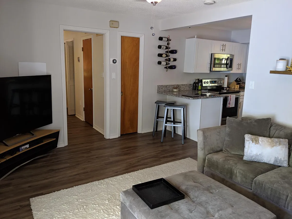 Looking from the living room towards the kitchen and bedroom door. - 600 S Lake Formosa Dr
