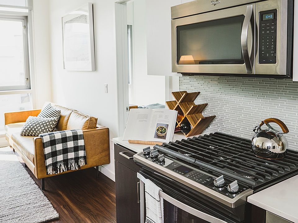 Gas cook top stove, glass tile backsplash and stainless steel appliances