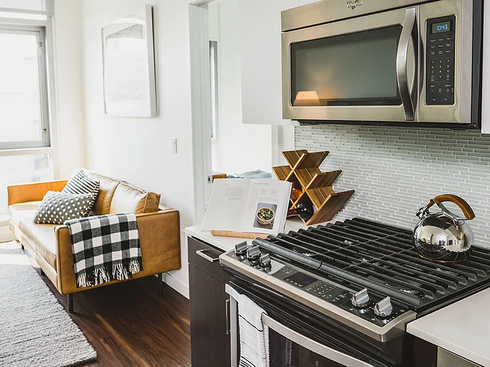 Gas cook top stove, glass tile backsplash and stainless steel appliances