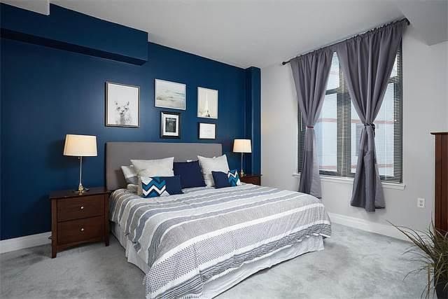 Bedroom (king size bed) with alfa shelving in large walk-in closet. *Renovation: Carpets replaced with wood flooring & walls painted white*