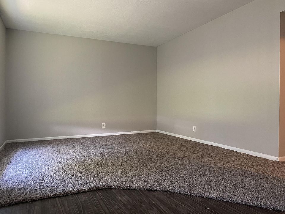 Living room with brand new flooring throughout apartment.