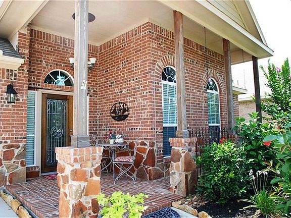 Gorgeous patio with custom Texas theme wrought iron railing .