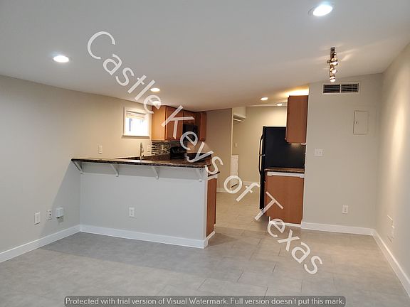 Living Room looking at the HUGE kitchen. There is a small breakfast nook on the right side of the kitchen entry.