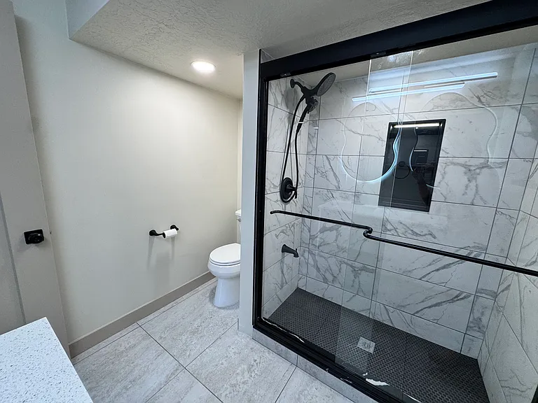 Master bathroom featuring a spacious walk-in shower with a clean, modern design.