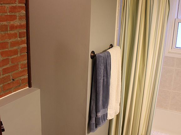 Bathroom with exposed brick