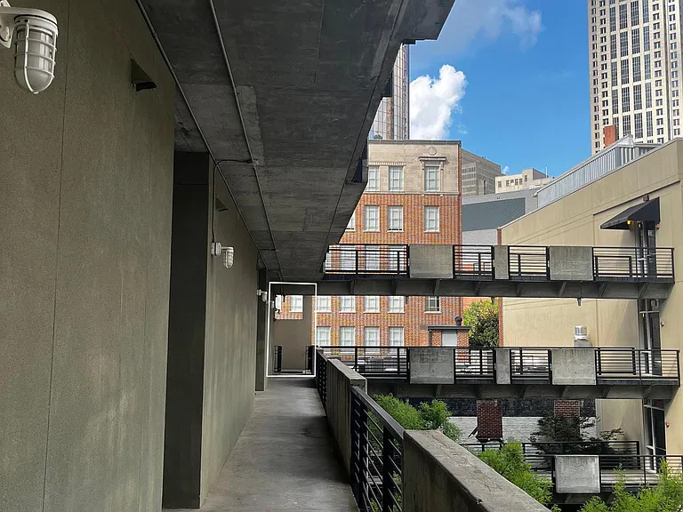 View towards unit from elevator. Tops of trees in courtyard can be seen at right.