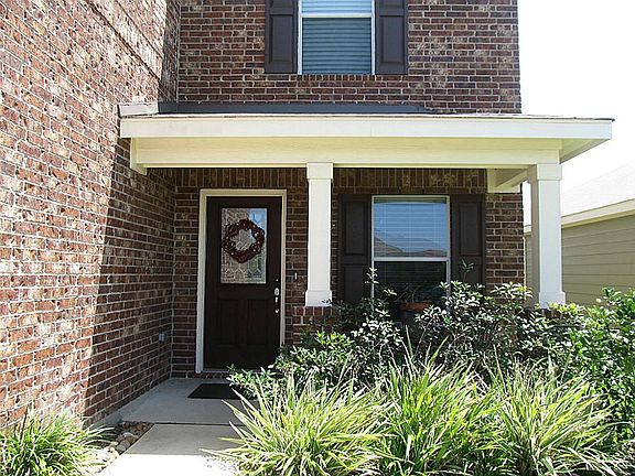 YOU COULD BE GREETING your guests at this beautiful entrance with a cover patio and a fantastic looking front door.