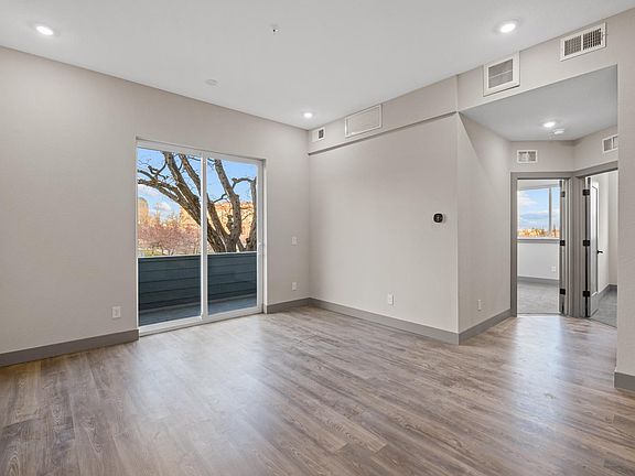Living Room with deck and entry to 2 bedrooms.