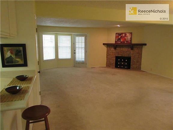 Spacious great room with bay window and door to patio.
