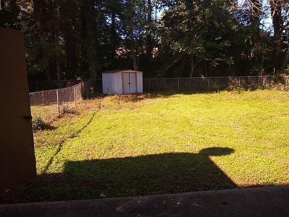 FENCED BACKYARD WITH SHED