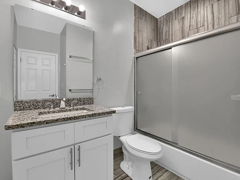 Bathroom - level 2: high-pressure tiled shower/tub, frosted glass by-pass shower doors, granite vanity, vent fan on a timer saves you money!