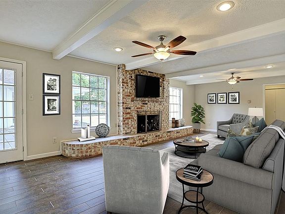 The Family Room is so welcoming. Overlooks the Pool and the Fireplace is a great focal point. The Beams add an architectural dimension plus the room is very large