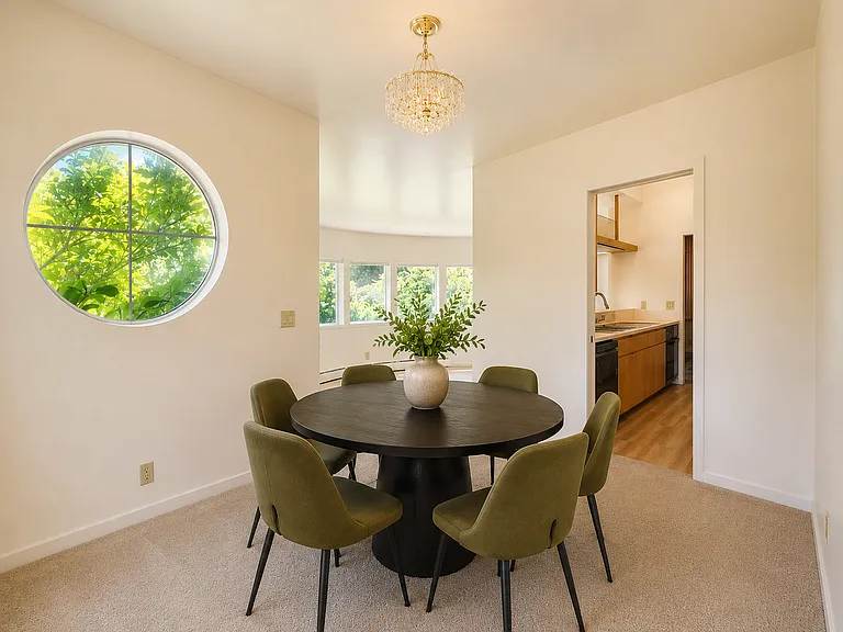 Virtually staged view back toward living room and kitchen.