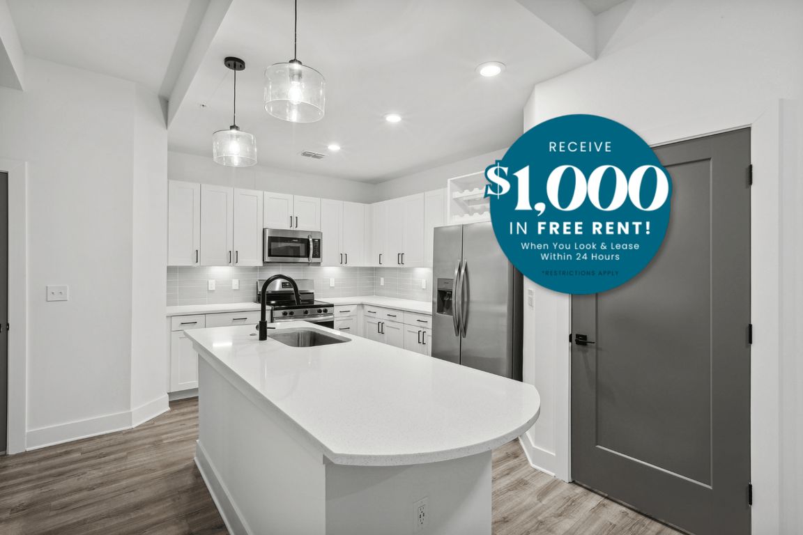 Kitchen with Quartz Countertop and Stainless Steel Appliances.