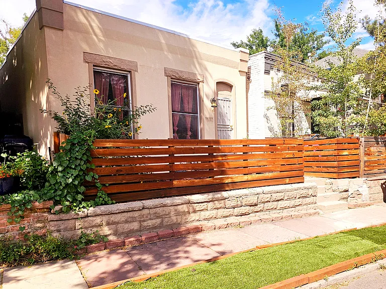Front of home with fenced in patio