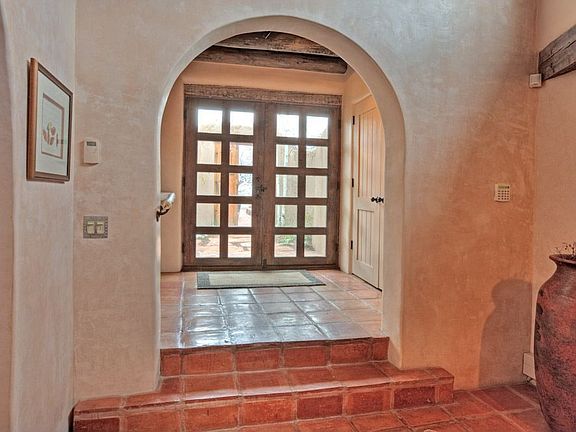 The foyer provides an appropriately serene & sophisticated introduction to the home. Its Saltillo-ti