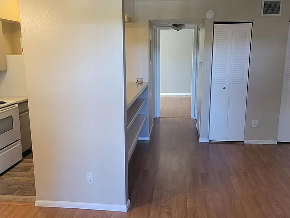 Living room looking toward bathroom and bedroom. Far right door is additional storage closet