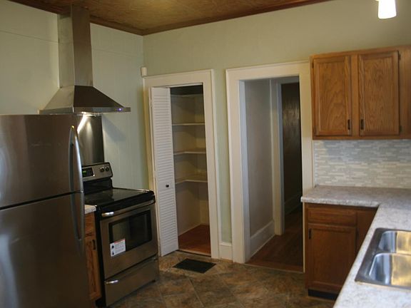 Kitchen has electric stove and small pantry