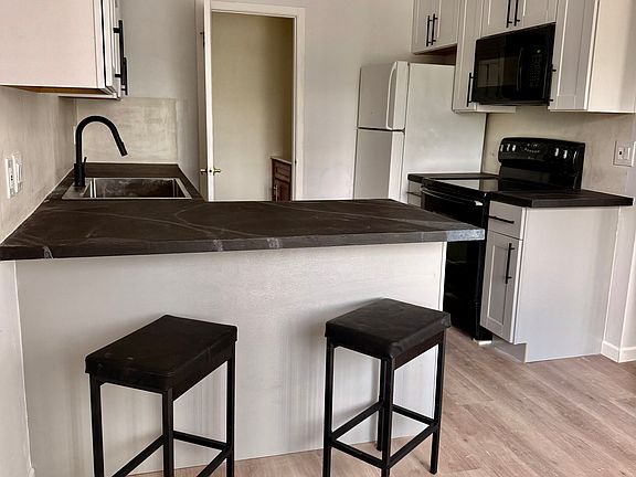 Kitchen and half bathroom in the back