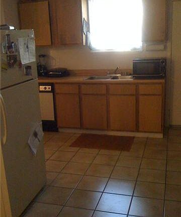 Upstairs has better layout; room enough for table, desk, and bar cart.