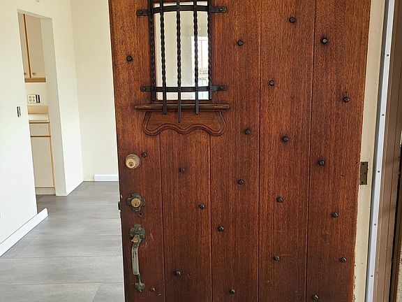Front door open looking beyond to dinning room