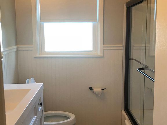 Bathroom w glass tub shower enclosure