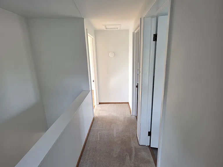 Upstairs hallway - bathroom to the right, followed by one bedroom; one bedroom to the left.