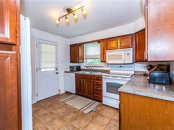 Updated kitchen with ceramic flooring and all white appliances included.