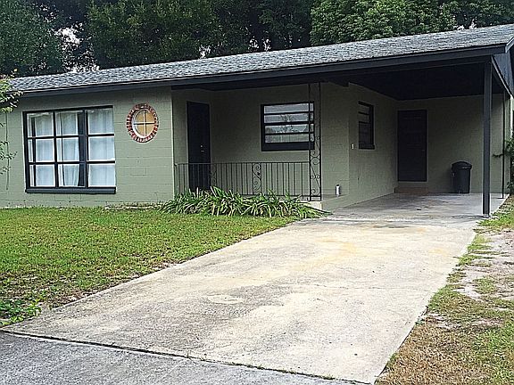 Front of property - private carport and driveway