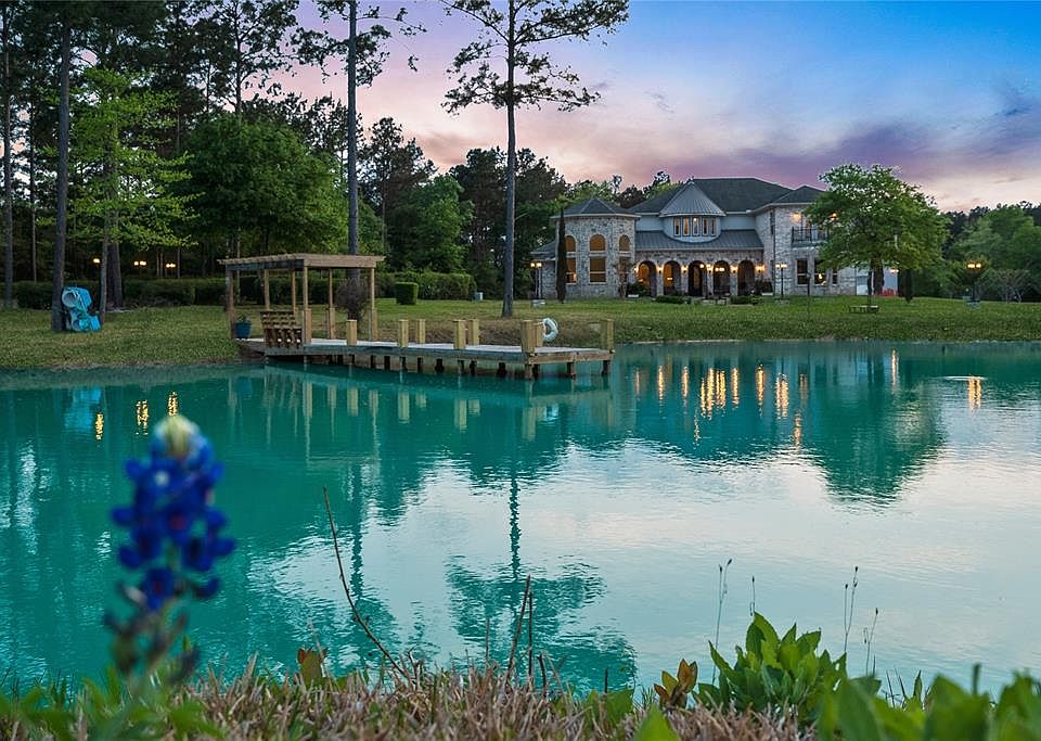 Welcome to 15212 Micrea Road. This beautiful 10 acre property is located north of Houston and includes a pond with dock at front of the home.