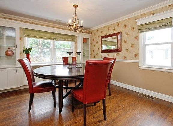 Bright and airy dining area framed by built-ins.