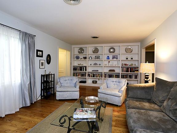 Another view looking back at the entry and bookshelves. Door on the right leads to the open kitchen 