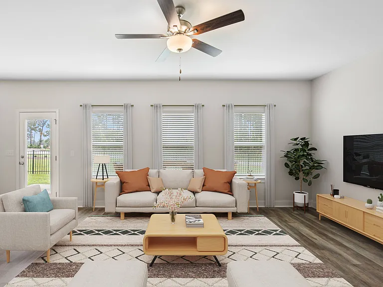 Sophisticated living space with a crisp white sofa, natural wood accents, and modern ceiling fanwhere comfort meets timeless design.