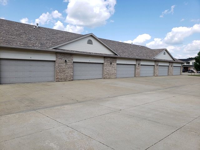 BACK OF APARTMENT BUILDING WITH 2 CAR GARAGE
