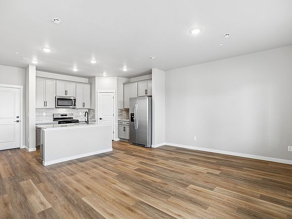 The living room is spacious and off of the kitchen.