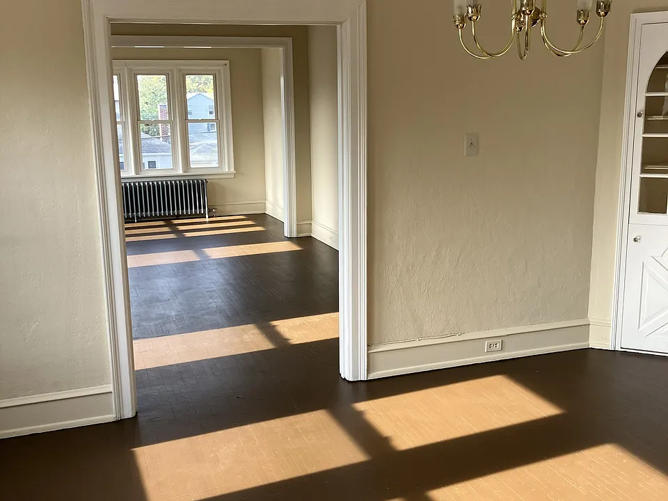 dining room looking into living room, built in hutch in right corner