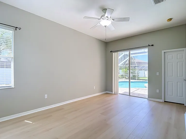 Bedroom #5 with sliding glass doors to pool deck.
