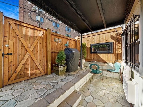 Private patio in the rear with new cedar fence, lovely seating area with a grill for your personal use.