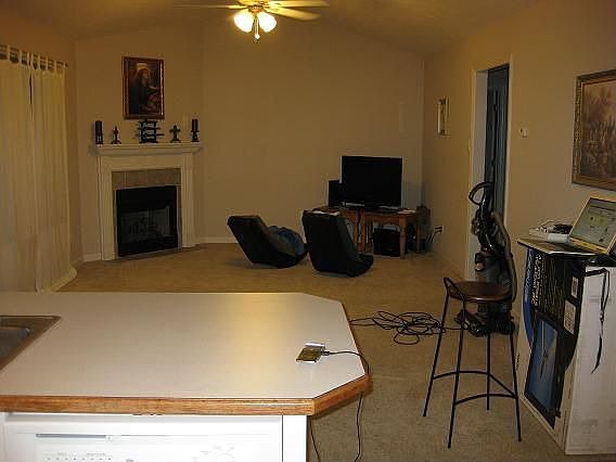 Kitchen opens to living room, with fireplace