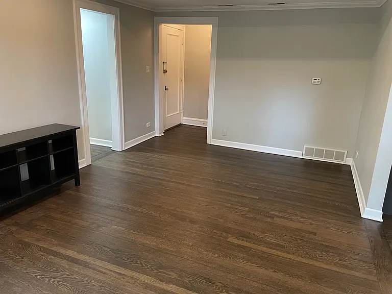 View from living room windows towards front door and hallway to bed/bath