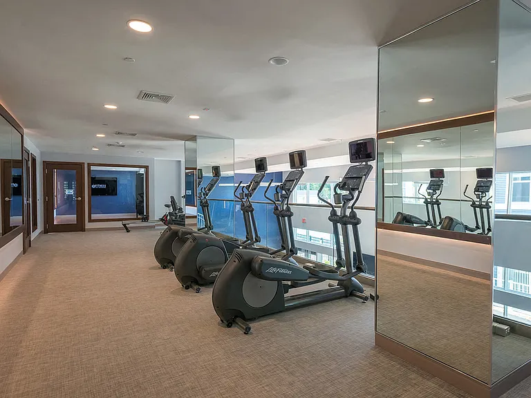 Floor-to-ceiling windows in the 24/7 fitness center let in natural light