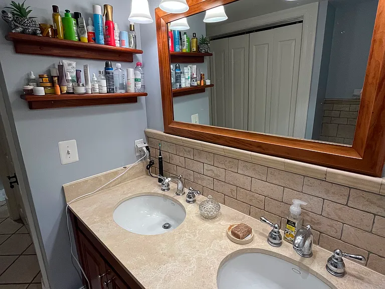 Double sinks inset in marble with cherry cabinets - same design and implementation as Master suite downstairs.