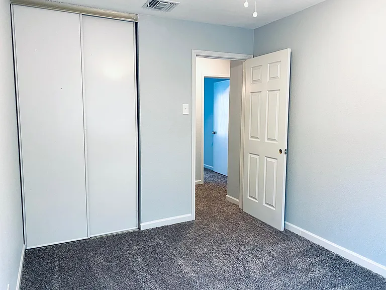Upstairs back bedroom. Closet on left.