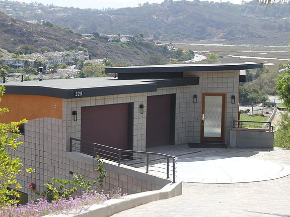 Front of home with Car Turner in front of garages.